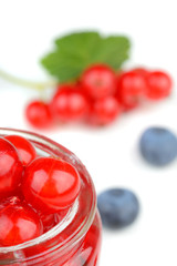 Red currants in a small jar with assorted berries