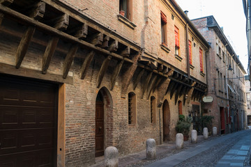Fototapeta na wymiar Medieval street in Ferrara with a Trattoria