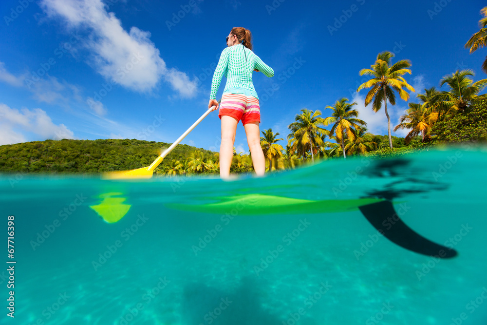 Wall mural Active young woman on vacation