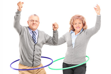 Mature man and woman exercising with hula hoop © Ljupco Smokovski