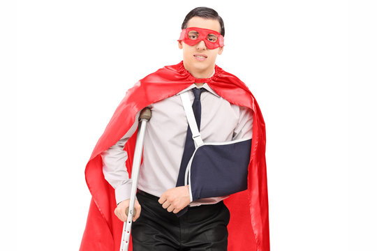 Male superhero with broken arm and a leg