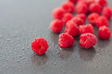 fresh raspberries  on wet surfaces