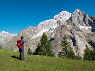 Fototapeta na wymiar Hiker admiring mountain landscape around Mont Blanc, Courmayer