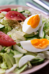 Summer salad with tomatoes, egg, cucumbers