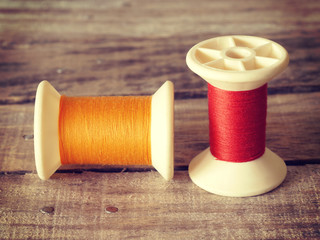 thread rolls on wood background old retro vintage style