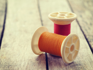thread rolls on wood background old retro vintage style