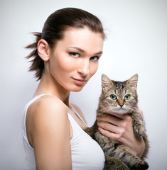 Portrait of young beautiful lady with a cat