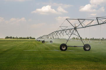 Self-propelled sprinkler installation waters mowed lawn