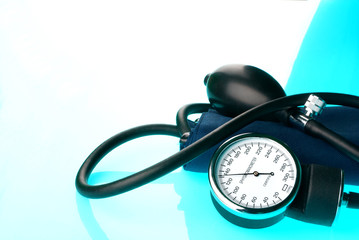 Sphygmomanometer on blue, reflective background