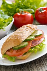 sandwich with ham and fresh vegetables, vertical