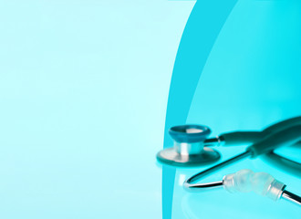 Stethoscope on blue, reflective background