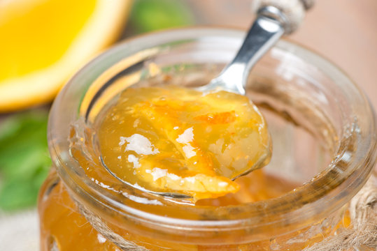 Spoon Of Orange Marmalade In A Glass Jar, Close-up