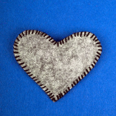 gray felt heart on a blue background