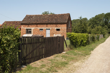 Fototapeta na wymiar Old Farmhouse, Wooden Gate & Dirt Road