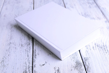 White book on wooden table background
