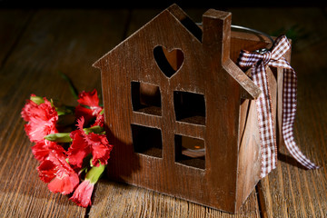 Small wooden house on wooden table close-up