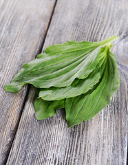 Plantain leaves on wooden background © Africa Studio