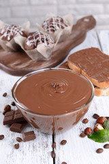 Sweet chocolate cream in bowl on table close-up