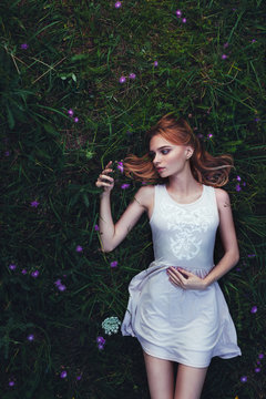 fabulous portrait woman lying down in field with flowers