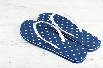 Color flip-flops on wooden background