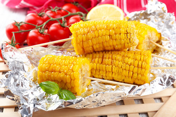 Grilled corn cobs on table, close-up