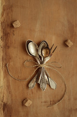 Bunch of vintage teaspoons and lemon fork tied up with bow