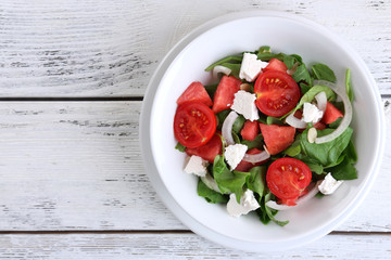 Salad with watermelon, onion, arugula and spinach leaves