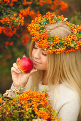 Girl in Orange wreath with Red Apple in hand