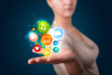 Young woman presenting colorful technology icons and symbols