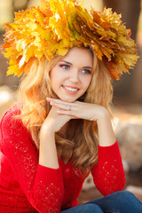 Portrait of beautiful young woman in autumn park.