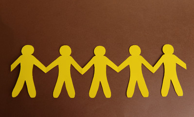 Paper people on brown background