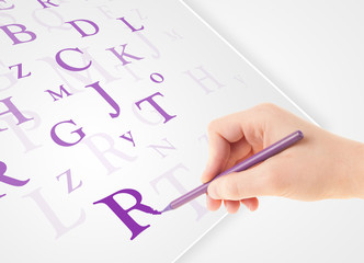 Hand writing various letters on white plain paper