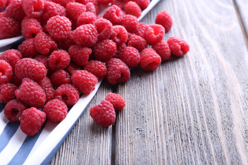 Ripe sweet raspberries on table close-up