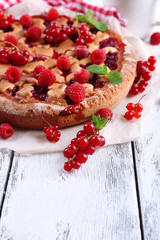 Tasty cake with berries on table close-up
