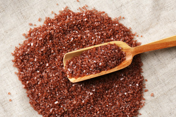 Sea salt in wooden spoon, close up