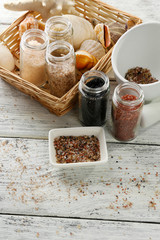 Different sea salt on wooden table, close up