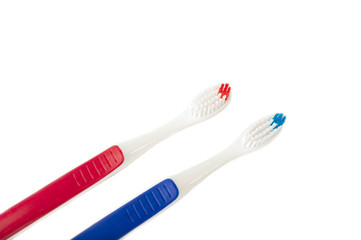 Two toothbrushes of different colors on white