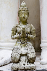 Fototapeta na wymiar Front view of Thai angel statue in temple