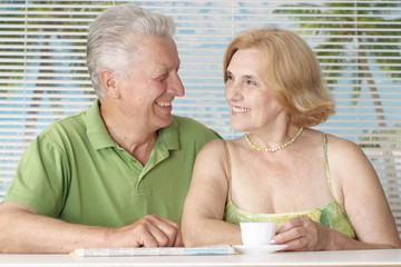 Happy older couple drink coffee