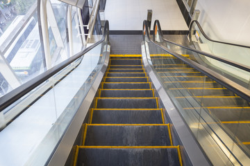 Empty escalator or moving stair. Also called stairway or staircase. Modern architecture design with...