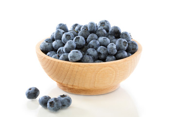 Blueberry fruit in a wooden bowl .