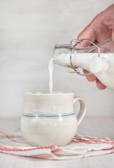 Man hand pouring milk from bottle
