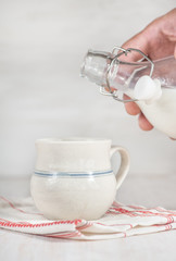 Man hand pouring milk from bottle