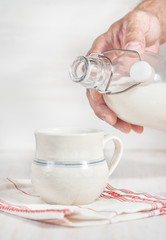 Man hand pouring milk from bottle