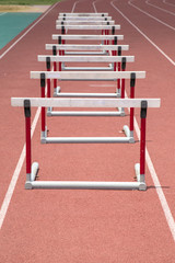 Hurdles on the red running track