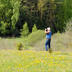 Old  man photographer photographing in nature