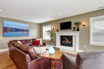 Living room with cozy fireplace and leather couch