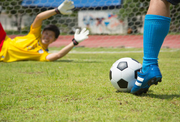 Attack soccer player shooting to defense team