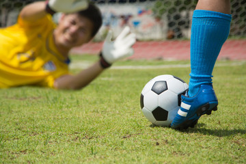 Attack soccer player shooting to defense team