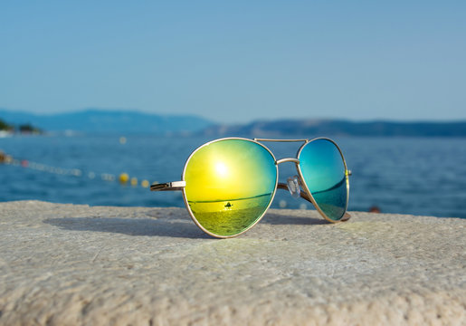 Sunglasses with sea reflection